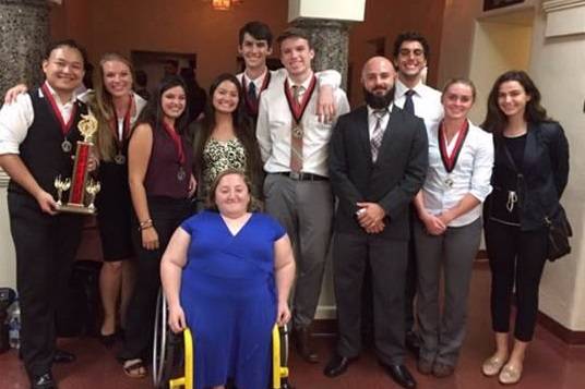 Mesa College's debate team proudly poses with their trophy and medals. The team had a successful first outing of the season at the Aztec Mills Invitational Tournament during the weekend of Sept. 30.